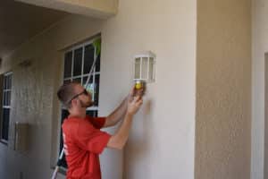 Changing light bulb in outdoor sconce