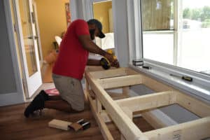 Man Putting Together Window Seat storge bench